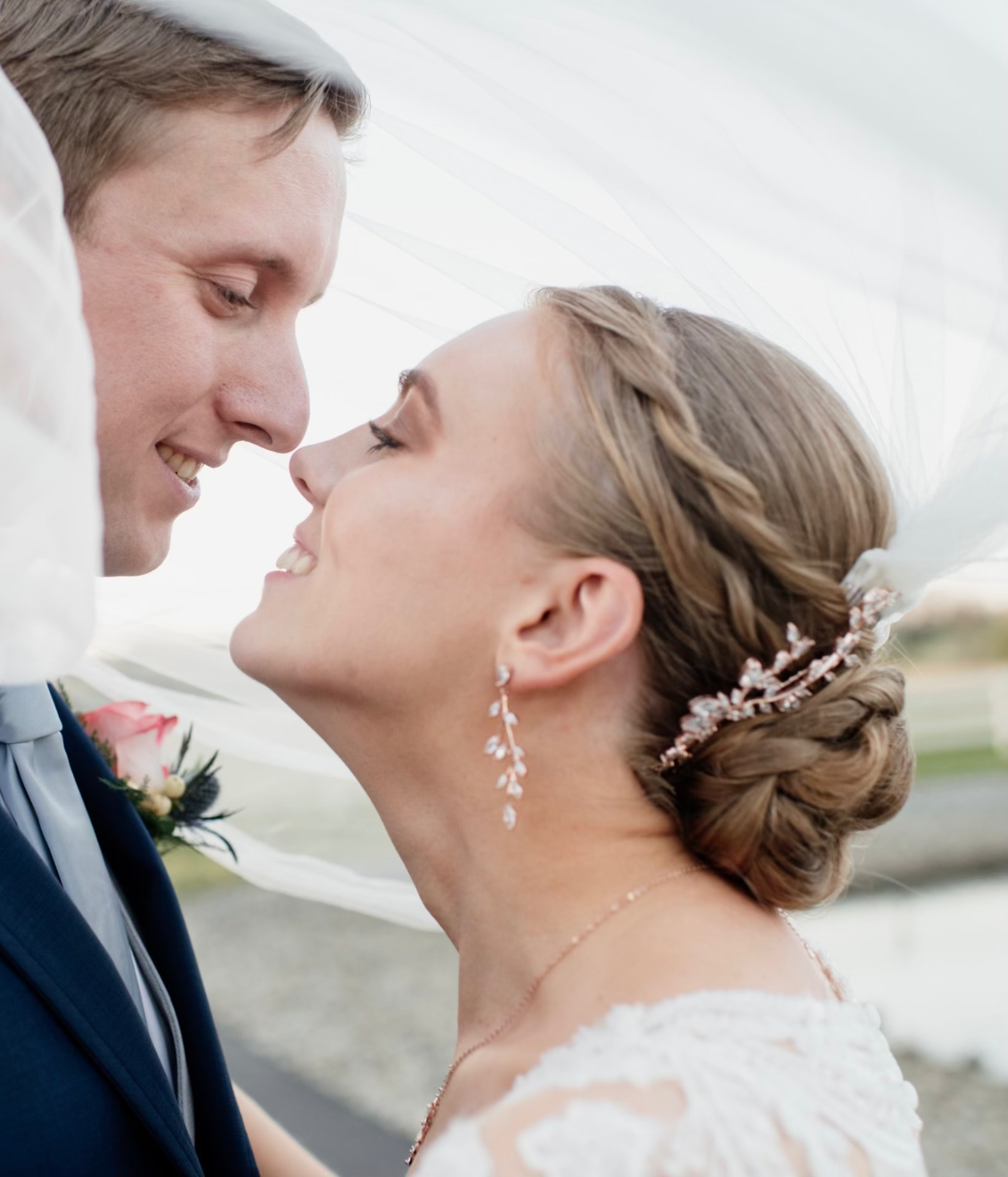 Elegant bridal updo with soft twists and pearl accents by Mill & Mane, Tipp City