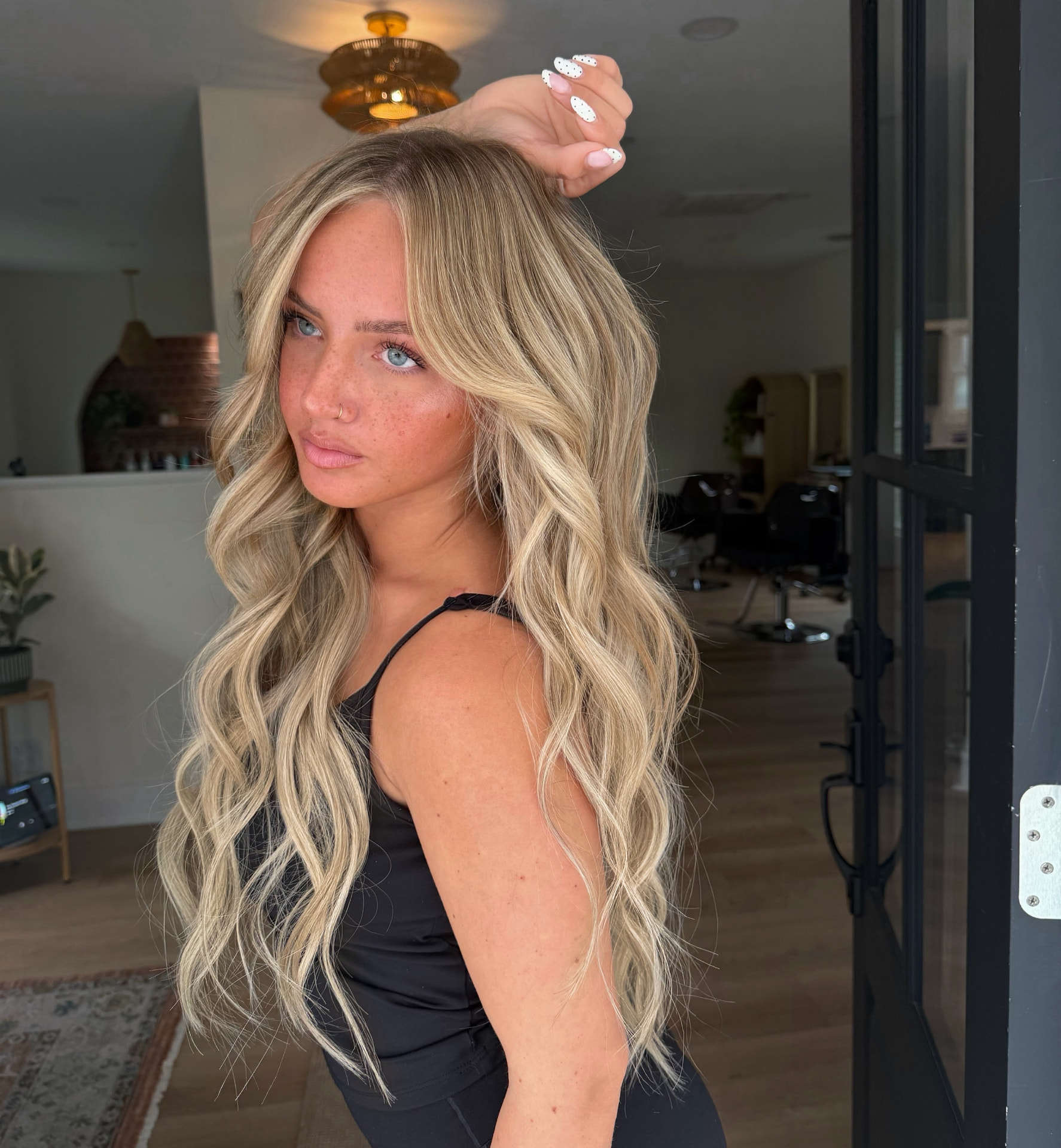 Long dimensional blonde waves with soft blended highlights by Mill & Mane, Tipp City