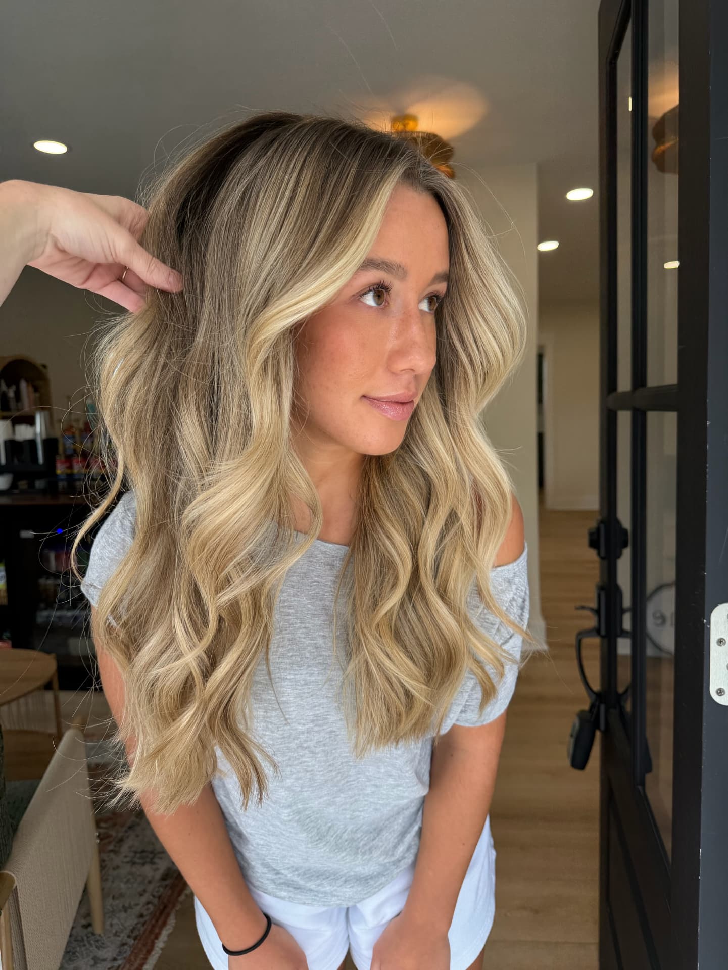 Dimensional blonde balayage with soft waves styled at Mill & Mane Hair Co., Tipp City